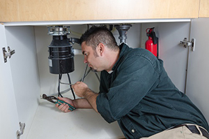 Tom is fixing a broken garbage disposal in Tolleson, AZ