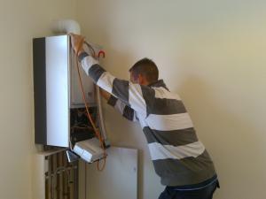 Plumbing contractor setting up a tankless heater during an installation